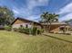 View of house's side, showcasing tan walls and brown accents at 1700 Curry Trl # 35, North Venice, FL 34275