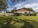 House's back exterior with fenced yard at 1700 Curry Trl # 35, North Venice, FL 34275