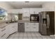 Modern kitchen with stainless steel appliances and white cabinets at 1700 Curry Trl # 35, Nokomis, FL 34275