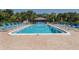 Community pool with plenty of lounge chairs at 1700 Curry Trl # 35, North Venice, FL 34275