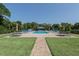 Community pool with lounge chairs and picnic tables at 1700 Curry Trl # 35, Nokomis, FL 34275