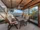 Relaxing screened porch with wooden table and chairs at 1700 Curry Trl # 35, North Venice, FL 34275