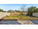 Landscaped backyard with pavers and open field views at 10710 Southern Forest Dr, Riverview, FL 33578