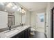 Bathroom with double vanity, large mirror, and shower at 10710 Southern Forest Dr, Riverview, FL 33578