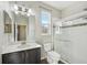 Clean bathroom with dark vanity, frameless shower, and tile flooring at 10710 Southern Forest Dr, Riverview, FL 33578