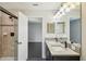 Bathroom with double vanity, large mirror and shower at 10710 Southern Forest Dr, Riverview, FL 33578