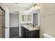 Modern bathroom with double vanity and a large mirror at 10710 Southern Forest Dr, Riverview, FL 33578