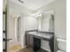 Bathroom with single vanity, mirror, and dark brown cabinets at 10710 Southern Forest Dr, Riverview, FL 33578