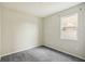 Bright bedroom with grey carpet and large window at 10710 Southern Forest Dr, Riverview, FL 33578