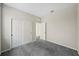 Well-lit bedroom featuring grey carpet and double-door closet at 10710 Southern Forest Dr, Riverview, FL 33578
