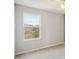 Simple bedroom with window and neutral colored walls at 10710 Southern Forest Dr, Riverview, FL 33578