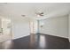 Bedroom with hardwood floors, ceiling fan, and access to hallway at 10710 Southern Forest Dr, Riverview, FL 33578