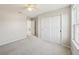 Bedroom with carpet, ceiling fan, and double door closet at 10710 Southern Forest Dr, Riverview, FL 33578