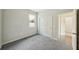 Spacious bedroom with grey carpet, double door closet, and bathroom access at 10710 Southern Forest Dr, Riverview, FL 33578