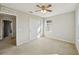 Bright bedroom with ceiling fan, carpet, and window at 10710 Southern Forest Dr, Riverview, FL 33578