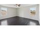 Bedroom with hardwood floors and two windows at 10710 Southern Forest Dr, Riverview, FL 33578