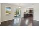 Open concept dining area with dark hardwood floors and kitchen views at 10710 Southern Forest Dr, Riverview, FL 33578