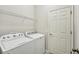 Laundry room with washer, dryer, and shelving at 10710 Southern Forest Dr, Riverview, FL 33578