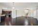 Open living room with dark hardwood floors, kitchen, and staircase at 10710 Southern Forest Dr, Riverview, FL 33578