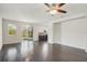 Spacious living room with dark hardwood floors and a ceiling fan at 10710 Southern Forest Dr, Riverview, FL 33578