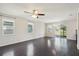 Spacious living room with dark hardwood floors and a ceiling fan at 10710 Southern Forest Dr, Riverview, FL 33578