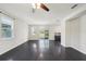 Spacious living room with dark hardwood floors and a ceiling fan at 10710 Southern Forest Dr, Riverview, FL 33578