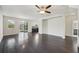 Spacious living room with dark hardwood floors and a ceiling fan at 10710 Southern Forest Dr, Riverview, FL 33578