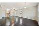 Spacious living room with dark hardwood floors and access to staircase at 10710 Southern Forest Dr, Riverview, FL 33578