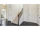 Elegant staircase features dark wood railing and neutral carpeting at 10710 Southern Forest Dr, Riverview, FL 33578