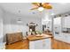 Kitchen with butcher block island, white cabinets and hardwood floors at 12631 Timber Run, Dade City, FL 33525