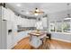 Modern kitchen featuring white cabinets, butcher block island, and hardwood floors at 12631 Timber Run, Dade City, FL 33525