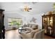 Bright living room featuring hardwood floors and comfy seating at 12631 Timber Run, Dade City, FL 33525