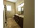 Double vanity bathroom with granite countertop at 13737 Victor Ave, Hudson, FL 34667