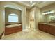 Elegant bathroom with soaking tub, walk-in shower, and double vanity at 13737 Victor Ave, Hudson, FL 34667