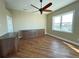 Bedroom with wood floors, built-ins, and large window at 13737 Victor Ave, Hudson, FL 34667