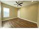 Bright bedroom with hardwood floors and ceiling fan at 13737 Victor Ave, Hudson, FL 34667