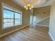 Spacious dining room featuring hardwood floors and large windows at 13737 Victor Ave, Hudson, FL 34667