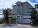 Gray two-story house with a white garage door and palm trees at 13737 Victor Ave, Hudson, FL 34667