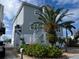 Three-story house with palm tree and landscaped yard at 13737 Victor Ave, Hudson, FL 34667