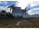 Two-story home with gray siding, white trim, and a landscaped yard at 13737 Victor Ave, Hudson, FL 34667