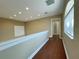 Bright hallway with hardwood floors and access to bedrooms at 13737 Victor Ave, Hudson, FL 34667