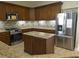 Modern kitchen with granite countertops and island at 13737 Victor Ave, Hudson, FL 34667