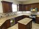 Modern kitchen with granite countertops and island at 13737 Victor Ave, Hudson, FL 34667