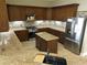 U-shaped kitchen with granite countertops and island at 13737 Victor Ave, Hudson, FL 34667