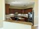 L-shaped kitchen with granite and stainless steel appliances at 13737 Victor Ave, Hudson, FL 34667