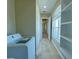 Laundry room with washer, dryer, built-in shelving and access to hallway at 13737 Victor Ave, Hudson, FL 34667