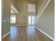 High-ceilinged living room with hardwood floors and double doors at 13737 Victor Ave, Hudson, FL 34667