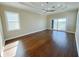 Bright main bedroom with hardwood floors and access to balcony at 13737 Victor Ave, Hudson, FL 34667