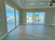 Main bedroom with hardwood floors and access to a balcony at 13737 Victor Ave, Hudson, FL 34667