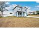 Newly built home with gray siding, a white fence, and a small front yard at 27096 Wakefield Dr, Brooksville, FL 34602